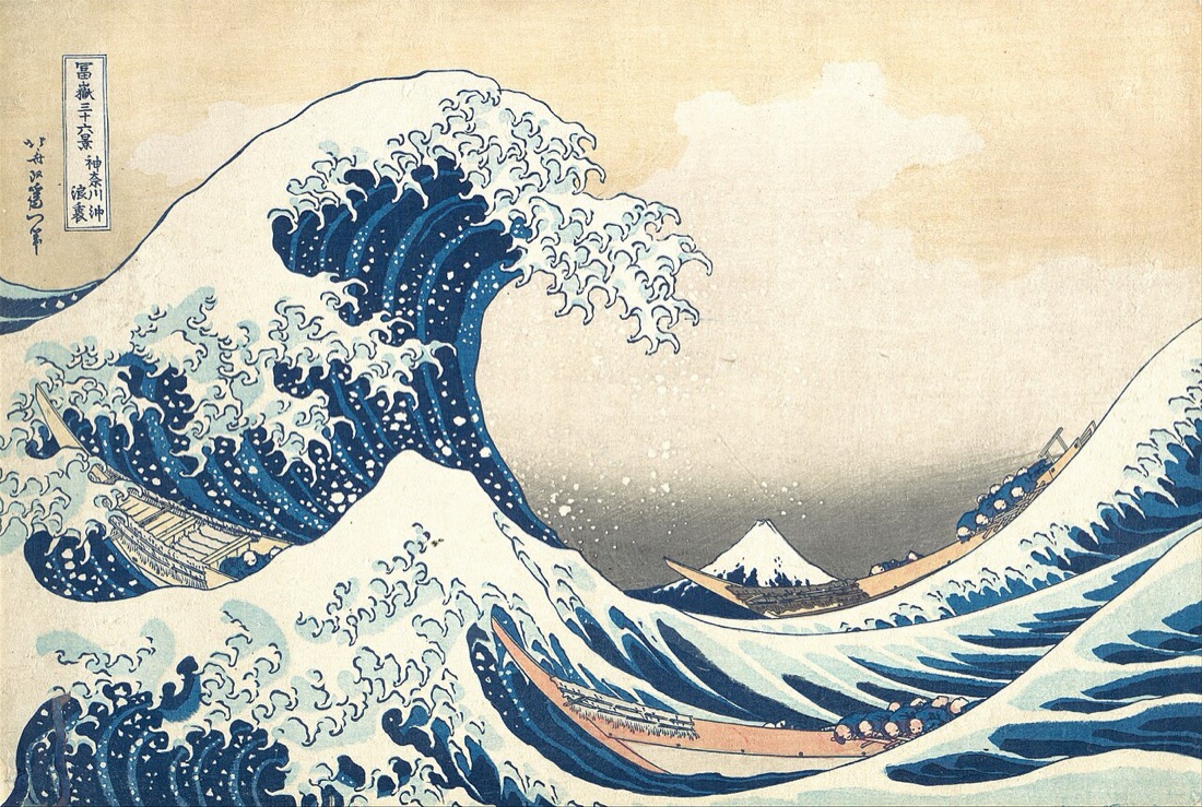 Katsushika Hokusai’s woodblock print Under the Wave off Kanagawa: a towering wave with claws of foam curls over three long rowing boats, while a small snow-capped Mount Fuji sits calmly in the hollow of the wave.